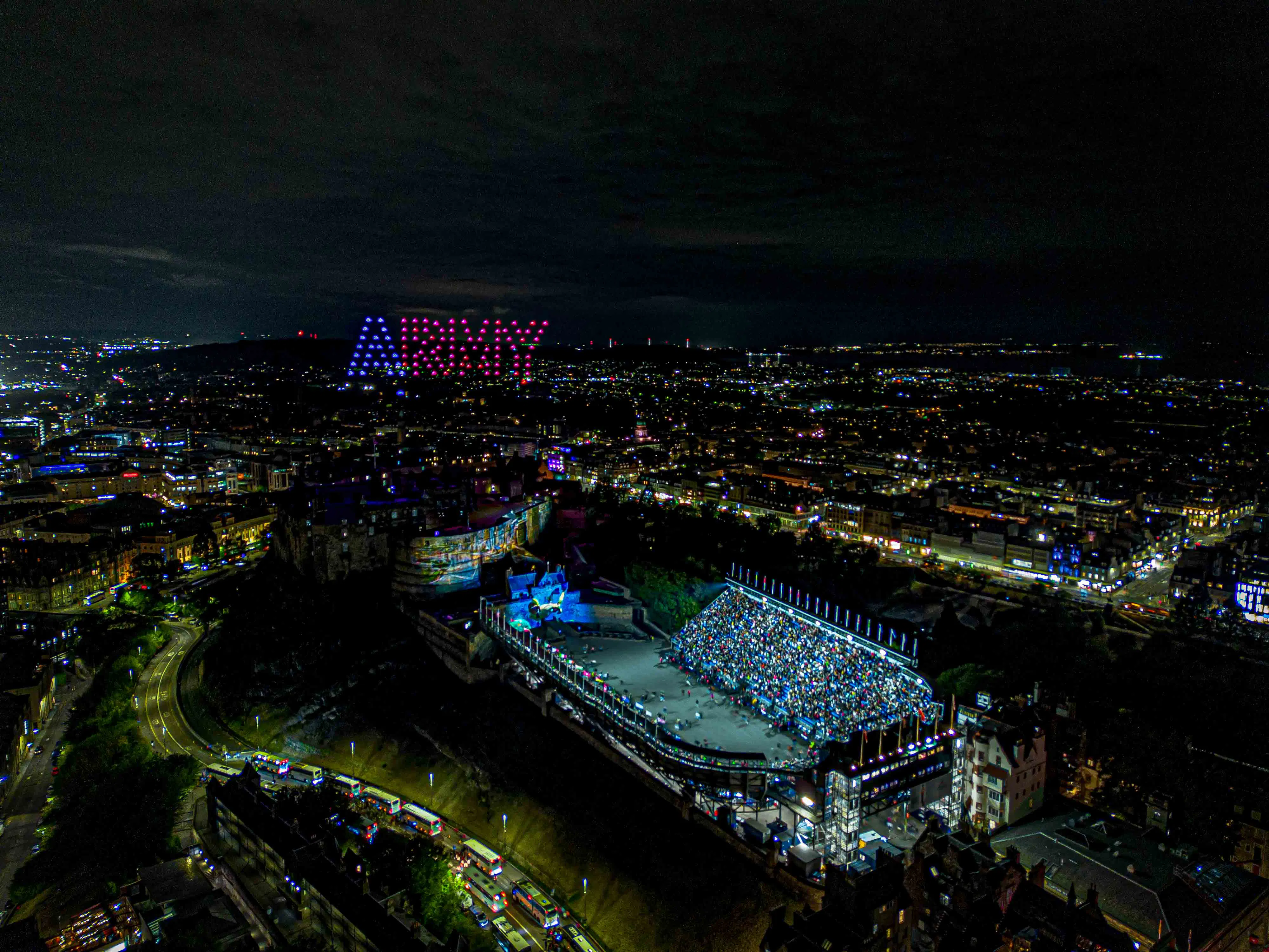 100 drones forming a display above Edinburgh Castle
